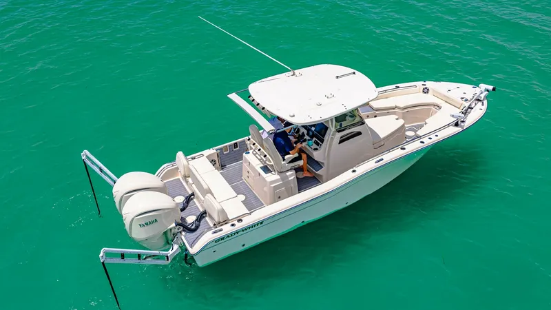 Slide: The Image of Aerial View of Grady-White 281 CE This image showcases the Grady-White 281 CE from an aerial perspective, highlighting its sleek design and spacious layout. The dual outboard engines promise powerful performance, while the ample deck space offers versatility for both fishing and leisure. - 7766868
