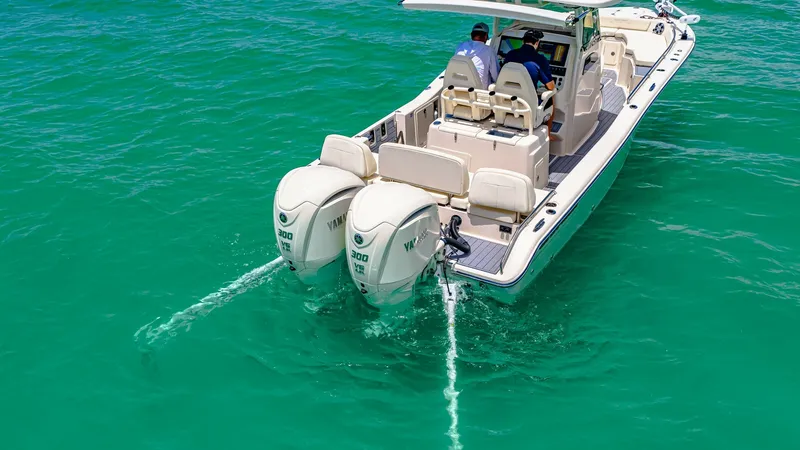 Slide: The Image of Aft Deck with Dual Outboard Engines This image showcases the sleek aft deck of the 2024 Grady-White 281 CE, featuring two powerful Yamaha outboard engines for superior performance. The spacious deck offers comfortable seating with plush cushions, ideal for relaxation or socializing while cr - 7766861