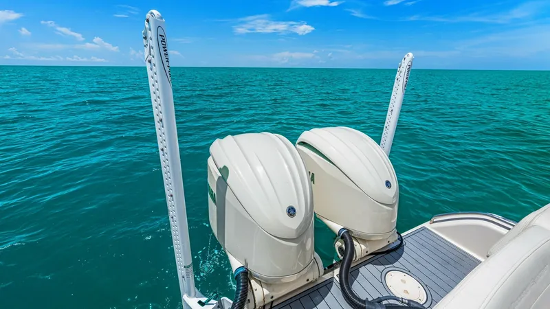 Slide: The Image of Twin Outboard Engines and Aft Deck This image showcases the powerful twin outboard engines on the 2024 Grady-White 281 CE, designed for superior performance and efficiency. The sleek aft deck features non-slip flooring, ensuring safety and comfort for all onboard activities. The expansive - 7766875
