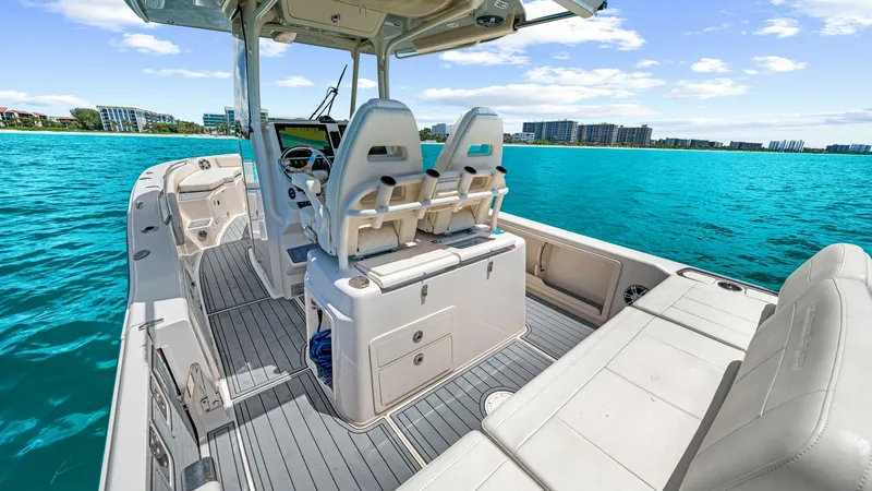 Slide: The Image of Center Console Helm and Seating The 2024 Grady-White 281 CE showcases a sleek center console helm with dual cushioned seats, offering both comfort and style for the captain and co-pilot. The helm features state-of-the-art navigation equipment, ensuring a smooth and enjoyable voyage. Sur - 7766871