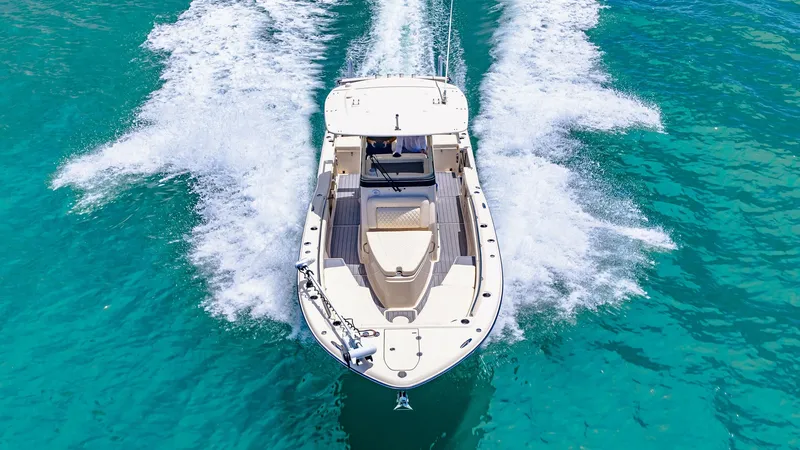 Slide: The Image of Aerial View of Bow in Motion This dynamic aerial shot captures the Grady-White 281 CE slicing through crystal-clear waters with precision. The spacious bow offers ample seating and sunbathing space, accentuated by sleek railings and a streamlined design. The vessel's powerful perform - 7766899