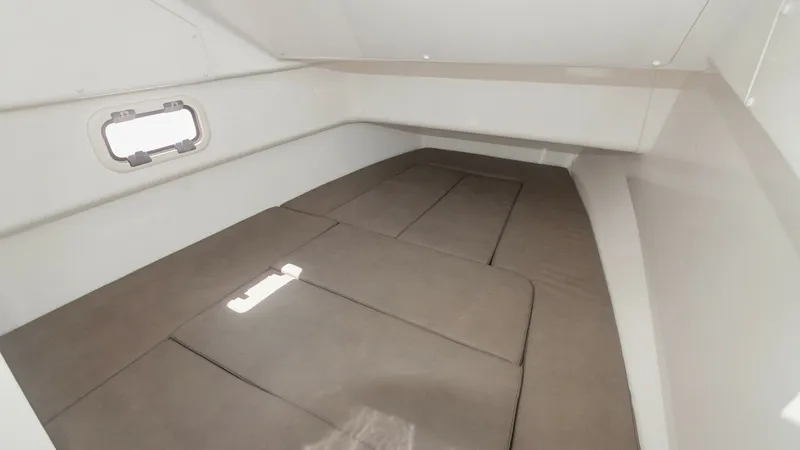 Slide: The Image of Cozy Cabin Berth Area This inviting cabin berth on the 2017 Zar Formenti 85 SL features a spacious cushioned sleeping area, providing comfort for overnight stays. The minimalist design is complemented by a small window that allows natural light to illuminate the space, enhanci - 7766824