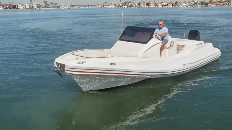 Slide: The Image of Bow and Helm View in Motion This image showcases the sleek design of the Zar Formenti 85 SL as it glides effortlessly through the water. The open bow provides ample seating, perfect for socializing or relaxing while underway. The modern helm station is equipped with a windscreen and - 7766837
