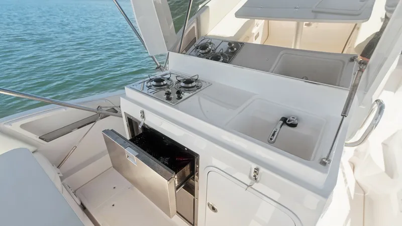 Slide: The Image of Outdoor Galley with Cooktop and Sink This image showcases the outdoor galley on the Zar Formenti 85 SL, featuring a sleek cooktop and double sink for convenient meal preparation. The stainless steel drawers provide ample storage, while the compact layout maximizes space efficiency. Perfect f - 7766819