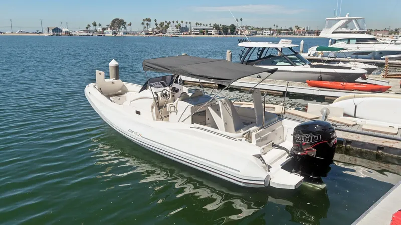 Slide: The Image of Aft View with Outboard Engine This 2017 Zar Formenti 85 SL showcases a sleek aft section featuring a powerful outboard engine, ensuring robust performance on the water. The spacious deck is equipped with a stylish T-top providing shade and comfort for passengers. Its well-designed lay - 7766838