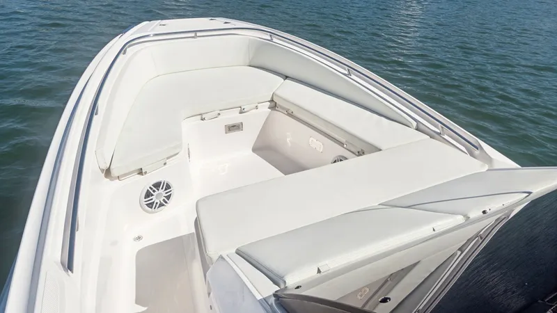 Slide: The Image of Spacious Bow Seating Area The bow of the Zar Formenti 85 SL features a spacious seating area with plush cushions, perfect for relaxing and enjoying the view. The sleek white upholstery complements the modern design, while built-in speakers enhance the onboard entertainment experie - 7766821