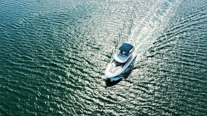 Slide: The Image of Aerial View of Meridian 391 Sedan This stunning aerial shot captures the 2006 Meridian 391 Sedan gracefully cutting through the water. The yacht's sleek design and spacious flybridge are showcased under the sun's glistening reflections on the sea. Ideal for both leisurely cruises and adve - 7766954