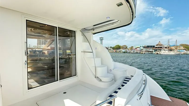 Slide: The Image of Aft Deck with Staircase Access This inviting aft deck on the 2006 Meridian 391 Sedan features a sleek staircase leading to the upper deck. The expansive sliding glass doors provide seamless access to the interior, enhancing the flow between indoor and outdoor spaces. With its polished - 7766944