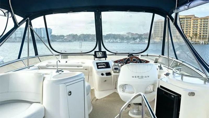 Slide: The Image of Flybridge Helm with Panoramic Views The 2006 Meridian 391 Sedan's flybridge offers a spacious helm area with panoramic views, ideal for navigation and relaxation. Featuring a well-appointed captain's chair, modern instrumentation, and ample seating, this area is designed for both comfort an - 7766914