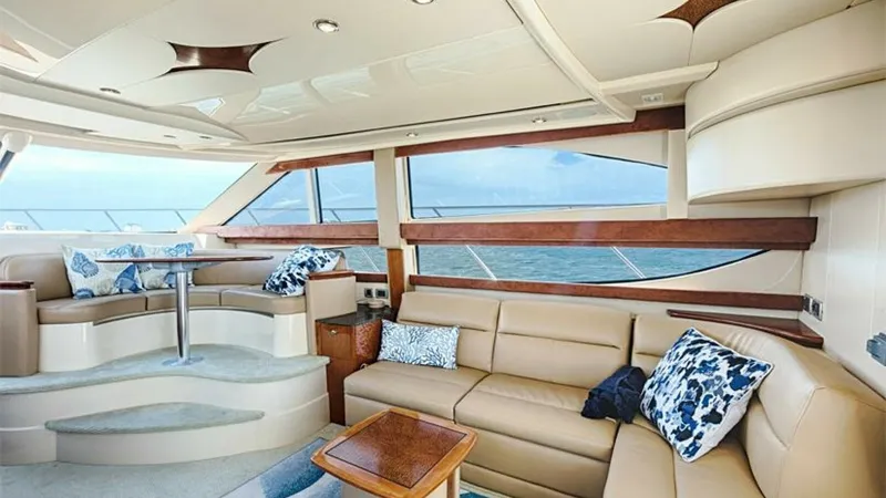 Slide: The Image of Spacious Salon with Panoramic Windows The salon of the 2006 Meridian 391 Sedan features expansive panoramic windows providing stunning ocean views. The luxurious seating area includes a plush L-shaped sofa and a raised dinette with elegant finishes. Soft, ambient lighting and tasteful decor c - 7766919