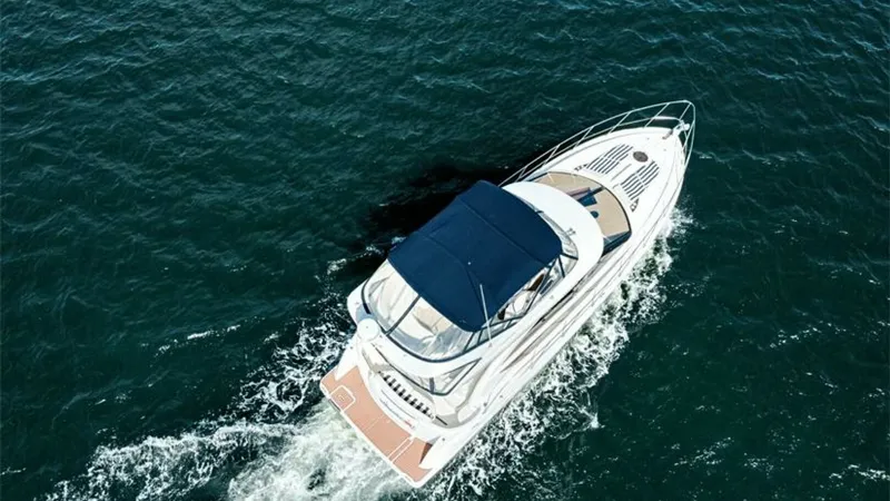 Slide: The Image of Aerial View of Flybridge and Bow This aerial shot of the 2006 Meridian 391 Sedan showcases the spacious flybridge with a protective canopy, providing an ideal vantage point for navigation and relaxation. The sleek bow design enhances the yacht's elegant profile, while the expansive deck - 7766957