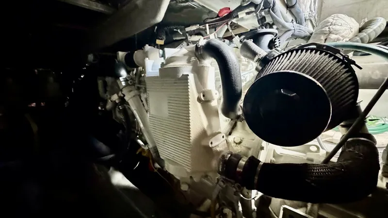 Slide: The Image of Engine Room with Diesel Engine This image showcases the well-maintained engine room of the 2006 Meridian 391 Sedan. The focus is on the robust diesel engine, highlighting its clean and organized setup. The room's efficient layout ensures easy access for maintenance, making it ideal for - 7824282