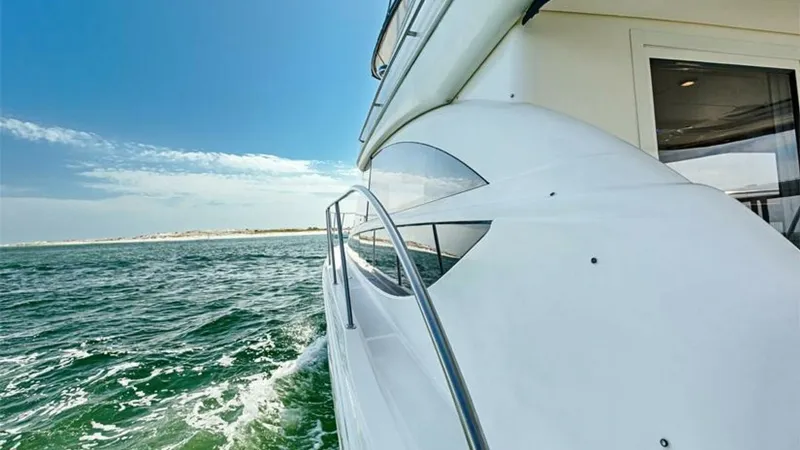Slide: The Image of Starboard Side Deck with Ocean View This image captures the starboard side deck of the 2006 Meridian 391 Sedan, showcasing its sleek lines and sturdy railing. The expansive view of the ocean creates an inviting atmosphere, perfect for enjoying leisurely cruises. The deck design emphasizes s - 7766948