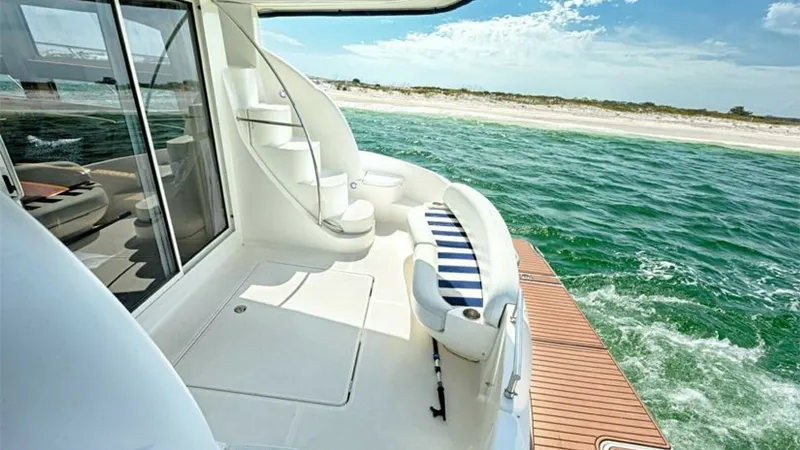Slide: The Image of Spacious Aft Deck with Swim Platform This inviting aft deck of the 2006 Meridian 391 Sedan offers ample space for relaxation and entertaining. Featuring a comfortable seating area with a striped cushion and easy access to the swim platform, it provides an ideal setting for enjoying the surro - 7766946