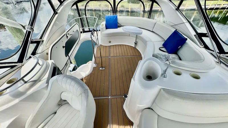 Slide: The Image of Flybridge with Seating and Helm The flybridge of the 2006 Meridian 391 Sedan offers spacious seating with plush white upholstery, accented by vibrant blue cushions. Designed for comfort and functionality, the area includes a sleek helm station, ample storage, and a stylish teak-look dec - 7824269