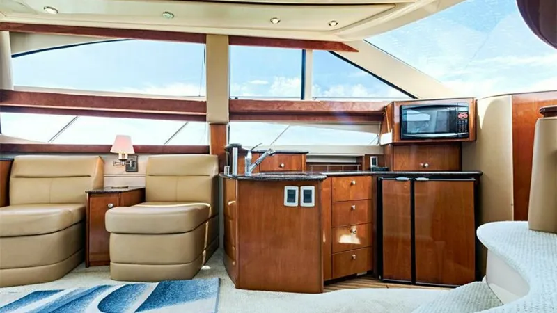 Slide: The Image of Salon with Galley and Seating This inviting salon area of the 2006 Meridian 391 Sedan features plush, cream-colored seating that offers a comfortable and elegant space for relaxation. The compact yet functional galley is equipped with modern appliances, including a microwave and dual - 7766918