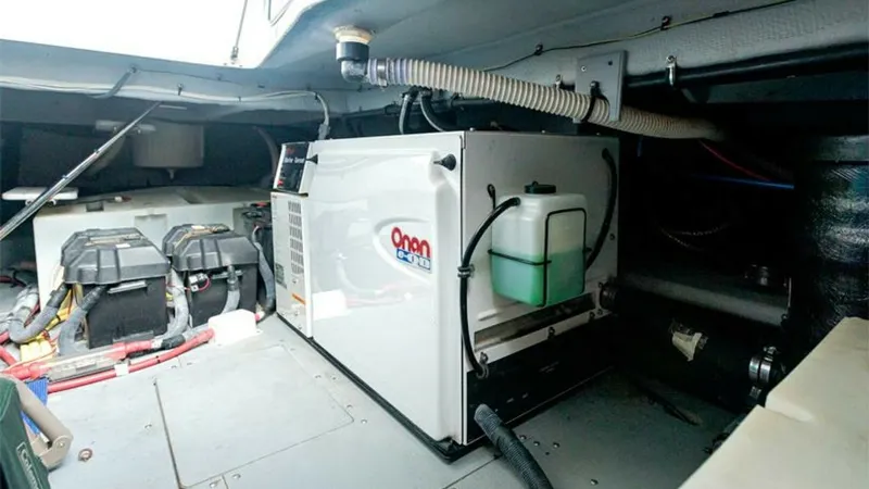 Slide: The Image of Engine Room with Generator The engine room of the 2006 Meridian 391 Sedan features a neatly installed Onan generator, ensuring reliable power supply for all onboard systems. The space is well-organized, with easy access to batteries and essential mechanical components. The efficien - 7766952