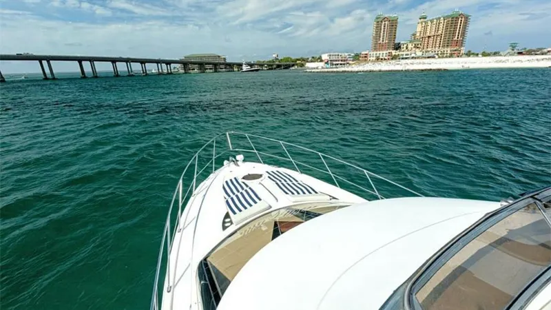 Slide: The Image of Bow View with Sunpads This image showcases the bow of the 2006 Meridian 391 Sedan, featuring spacious sunpads perfect for relaxation. The sleek lines and sturdy railings enhance safety and style, while the expansive view of the surrounding water and shoreline highlights its cr - 7766938