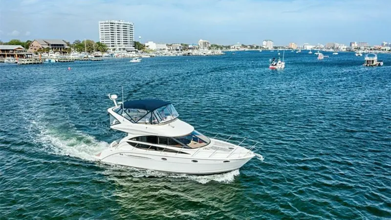 Slide: The Image of Aerial View of Meridian 391 Sedan This image captures the elegant Meridian 391 Sedan gliding through the water, showcasing its sleek lines and spacious flybridge. The yacht's dual-level design offers expansive views and ample space for relaxation and entertainment. With its classic silhou - 7766956