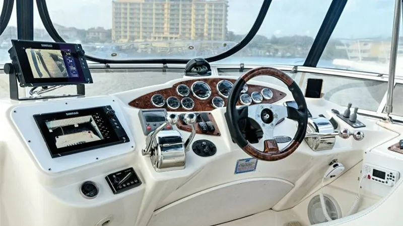 Slide: The Image of Helm Station with Navigation Equipment The helm station of the 2006 Meridian 391 Sedan is equipped with modern navigation technology, including dual displays and a comprehensive set of gauges. The sleek, ergonomic design features a polished wood console and chrome-finished controls, offering b - 7766934