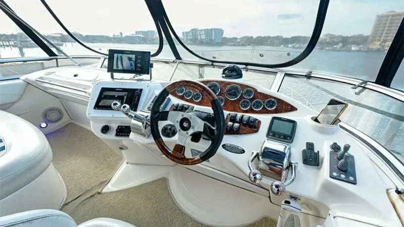 Slide: The Image of Helm Station with Panoramic View This helm station on the 2006 Meridian 391 Sedan offers a commanding view with expansive windows for optimal visibility. The dashboard features classic wood accents, modern navigation equipment, and intuitive controls for seamless operation. Luxurious lea - 7766935
