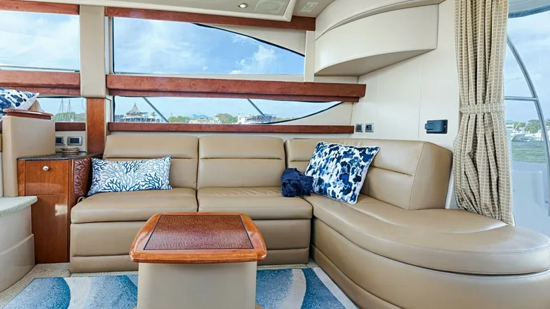 Slide: The Image of Spacious Salon with Panoramic Windows The salon of the 2006 Meridian 391 Sedan features a plush, L-shaped leather sofa, perfect for relaxation and entertaining. Large panoramic windows flood the space with natural light and provide stunning views, enhancing the open and airy atmosphere. The e - 7766917