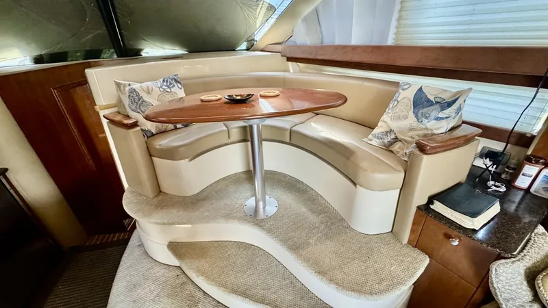 Slide: The Image of Elegant Salon Dinette Area This inviting salon dinette area on the 2006 Meridian 391 Sedan features plush, curved seating upholstered in soft beige leather, complemented by a stylish wooden table. The elevated design and panoramic windows provide a well-lit, cozy space for dining o - 7824248