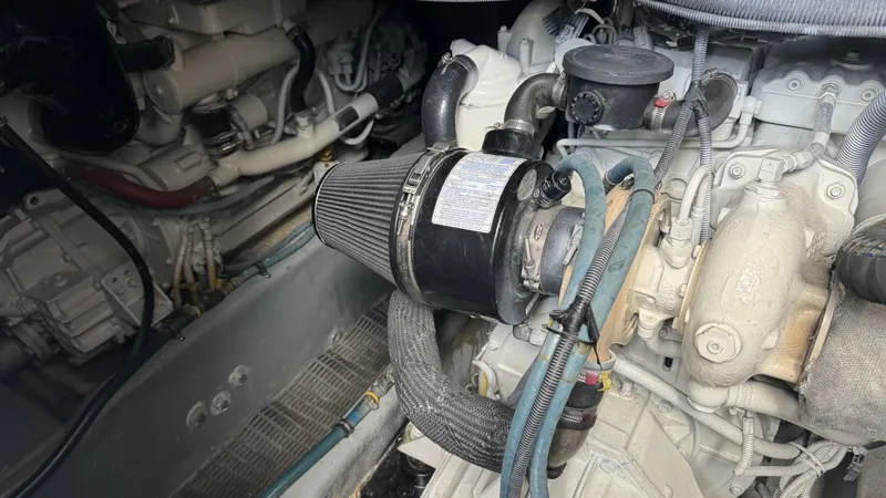 Slide: The Image of Engine Compartment with Diesel Engine The image showcases the engine compartment of the 2006 Meridian 391 Sedan, highlighting its robust diesel engine. The compartment is well-organized with clearly visible components, including hoses and a prominent air filter. This setup ensures efficient p - 7824283