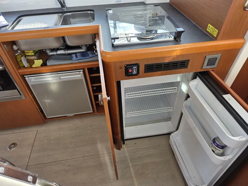 Slide: The Image of Galley showing main fridge (open) and additional under-sink fridge/freezer - 7818223