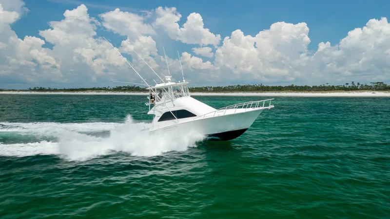 Slide: The Image of Cabo 43 Convertible In Action The Cabo 43 Convertible cuts through the water with impressive speed and agility, showcasing its sleek design and powerful performance. The vessel's crisp white exterior contrasts beautifully against the vibrant blue sea, while the spacious flybridge offe - 7831820