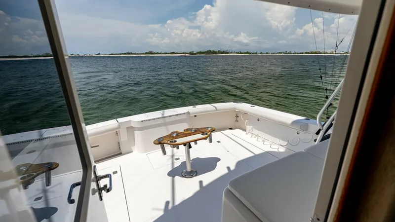 Slide: The Image of Spacious Cockpit with Ocean View The cockpit of the 2003 Cabo 43 Convertible offers an expansive and inviting space, perfect for fishing or leisurely activities. Featuring a sturdy central table and ample seating, this area is designed for comfort and functionality. The open layout provi - 7831810
