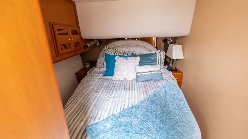 Slide: The Image of Cozy Guest Stateroom Interior The guest stateroom offers a comfortable and inviting space with a plush double bed adorned with coordinating pillows and a soft throw. Warm wood accents and built-in storage provide both style and functionality, while the soft lighting creates a relaxing - 7831798