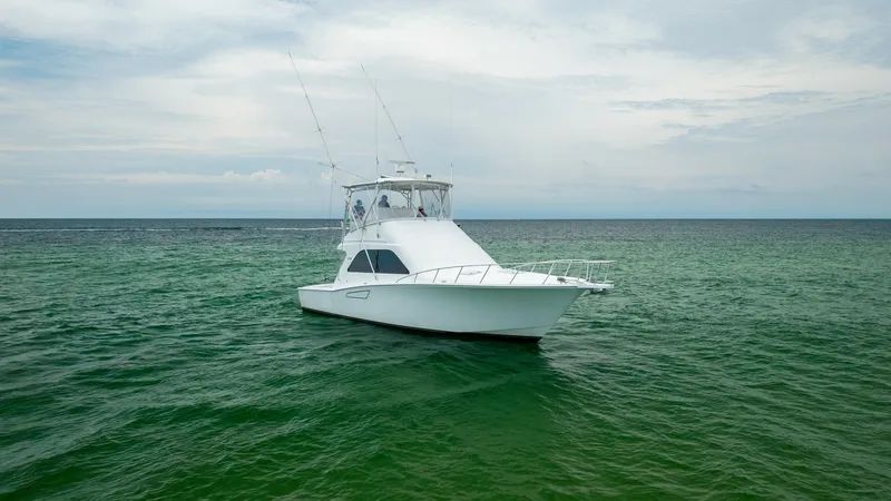 Slide: The Image of Bow View on Open Water This image showcases the bow of the 2003 Cabo 43 Convertible, 'Chao Bella', gracefully cutting through serene waters. The vessel's sleek lines and sturdy construction are evident, designed for both performance and comfort. With its elevated flybridge, thi - 7831817