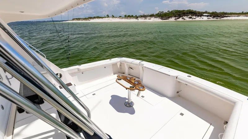 Slide: The Image of Spacious Cockpit with Tackle Station The cockpit of the 2003 Cabo 43 Convertible offers ample space for fishing and relaxation. It features a well-equipped tackle station, providing convenience for avid anglers. The clean, open layout ensures easy movement, with a backdrop of scenic waters e - 7831809
