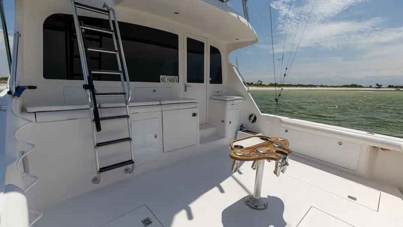 Slide: The Image of Spacious Fishing Cockpit The fishing cockpit of the 2003 Cabo 43 Convertible 'Chao Bella' offers a well-equipped and spacious area for angling enthusiasts. Featuring a central fighting chair, ample storage compartments, and a robust ladder leading to the flybridge, this cockpit i - 7831813