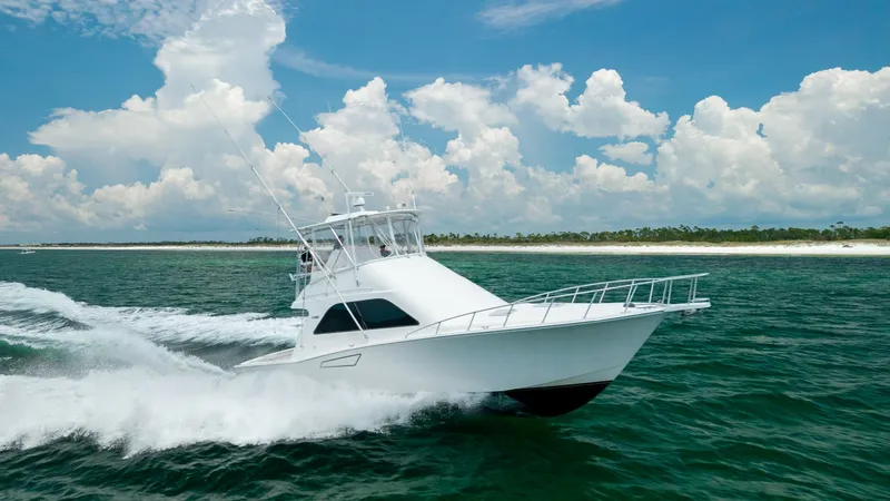 The Image of Dynamic Bow View in Motion The 2003 Cabo 43 Convertible, 'Chao Bella', is captured in full stride, cutting through the water with elegance and power. The sleek bow design enhances hydrodynamics, offering a smooth and efficient ride. Its classic white hull complements the vibrant oc - 7831781