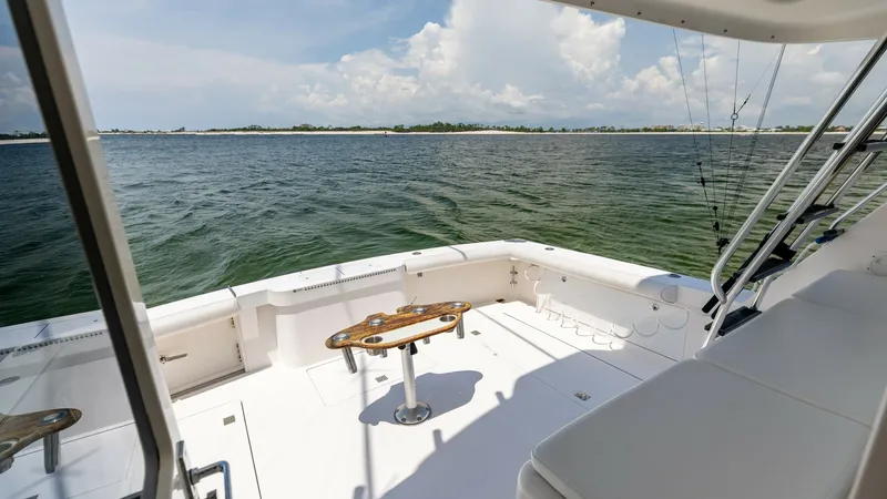 Slide: The Image of Spacious Aft Deck with Seating The aft deck of the 2003 Cabo 43 Convertible 'Chao Bella' offers a generous space ideal for both relaxation and fishing activities. Featuring a central mounted fighting chair, this area is designed for serious anglers, while the surrounding seating provid - 7831811