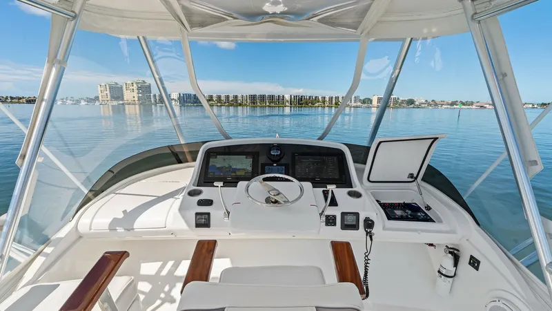 Slide: The Image of Flybridge Helm Station View Experience commanding views from the flybridge helm of the 2019 Bertram 35 Flybridge. The helm station features advanced navigation systems and ergonomic controls, ensuring a smooth and efficient operation. Enjoy the spacious seating area, offering comfor - 7851540
