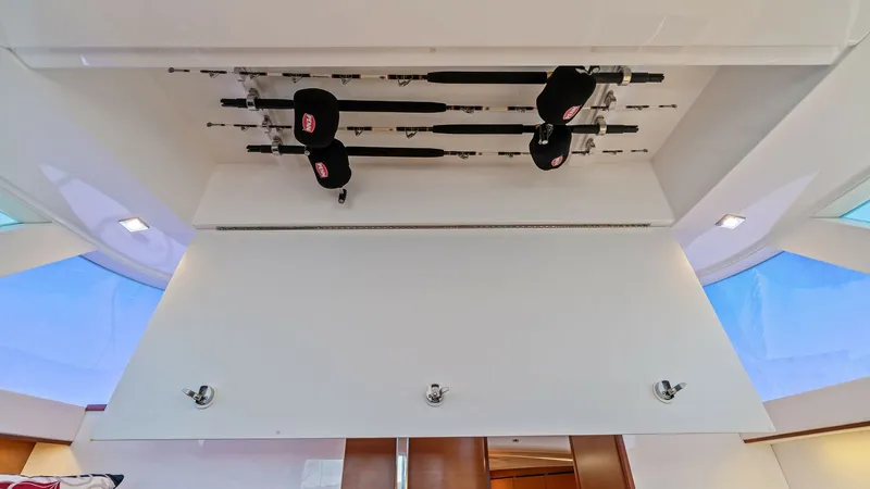 Slide: The Image of Overhead Rod Storage Compartment This image showcases the clever overhead rod storage compartment in the 2019 Bertram 35 Flybridge. The compartment efficiently organizes fishing rods, ensuring easy access and maximizing space. The sleek design complements the yacht's modern interior, enh - 7851525