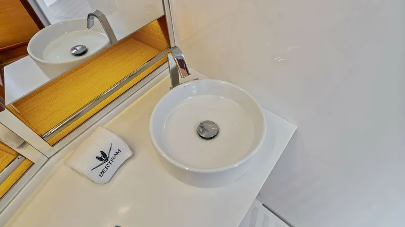 Slide: The Image of Modern Bathroom Vanity This sleek bathroom vanity features a contemporary round basin set against a glossy countertop. The minimalist design is complemented by a stylish chrome faucet and mirrored backsplash, enhancing the sense of space and light. High-quality finishes and att - 7851531