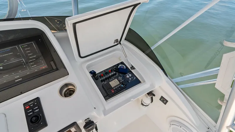 Slide: The Image of Flybridge Helm Station Controls This image showcases the helm station on the flybridge of the 2019 Bertram 35. The area is equipped with advanced navigation and communication systems, providing the captain with all essential controls. The clean, organized layout and modern touchscreen d - 7851538