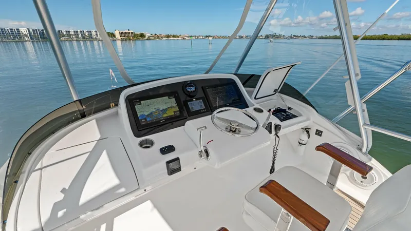 Slide: The Image of Flybridge Helm with Electronics The flybridge helm of the 2019 Bertram 35 Flybridge features advanced navigation systems with dual display screens and intuitive controls. The helm is designed for comfort and functionality, with cushioned seating and a panoramic view for optimal visibili - 7851536
