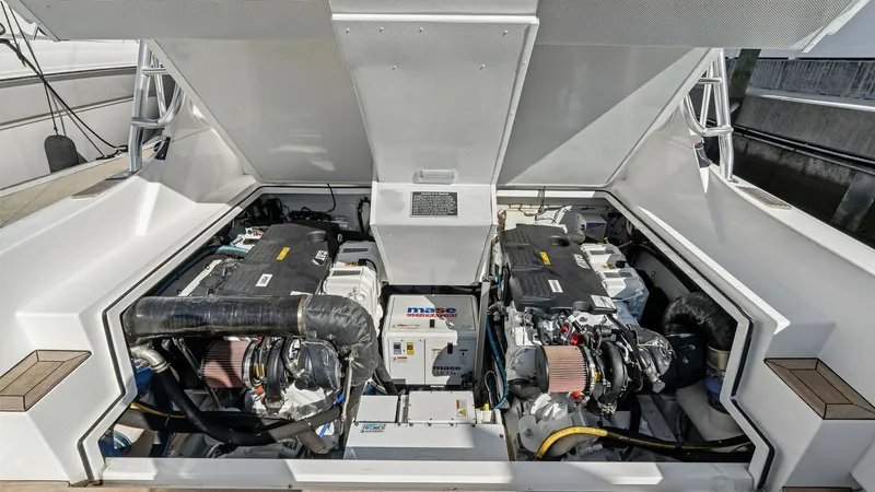 Slide: The Image of Engine Room with Twin Engines The engine room of the 2019 Bertram 35 Flybridge showcases a pair of powerful, well-maintained engines. The space is efficiently organized, featuring a clean layout with easy access for maintenance. Modern engineering and quality materials ensure reliable - 7851545