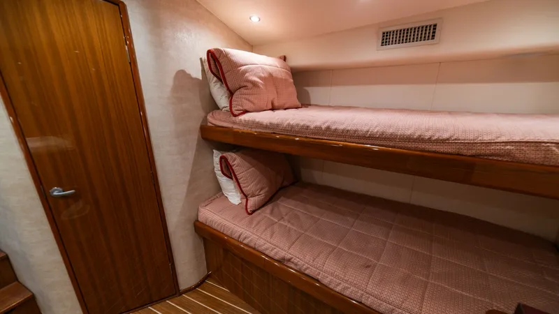 Slide: The Image of Guest Cabin with Bunk Beds This cozy guest cabin features stylish bunk beds with plush bedding, creating a comfortable retreat for guests. The warm wood finishes and soft, ambient lighting enhance the inviting atmosphere. Ample storage and efficient use of space make it an ideal se - 7854758