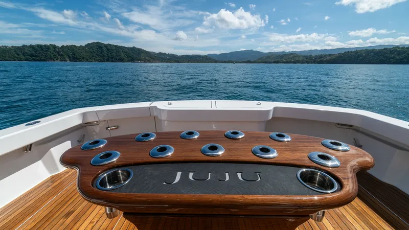 Slide: The Image of Aft Deck with Custom Fishing Station The aft deck of the Viking 46 BF showcases a sleek custom fishing station aboard JUJU. The elegantly crafted teak deck complements the stylish, engraved nameplate on the fishing station, surrounded by multiple rod holders and cup holders for convenience. - 7854744