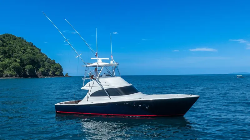 Slide: The Image of Side Profile of Viking 46 BF This image showcases the sleek side profile of the 2020 Viking 46 BF, highlighting its elegant lines and robust build. The vessel features a classic flybridge with dual outriggers, ideal for deep-sea fishing. The yacht's dark hull contrasts beautifully wi - 7854740