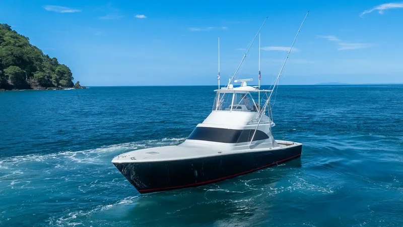 Slide: The Image of Viking 46 BF Exterior Profile This image showcases the sleek exterior profile of the 2020 Viking 46 BF, featuring a striking black hull complemented by a white superstructure. The vessel is equipped with a spacious flybridge and prominent outriggers, ideal for sport fishing. Its elega - 7854777