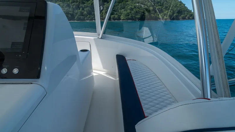 Slide: The Image of Helm Seating Area with Ocean View This image showcases the helm seating area of the 2020 Viking 46 BF, featuring a sleek and modern design. The comfortable, diamond-stitched seating provides an inviting space for relaxation while cruising. The panoramic windows offer stunning views of the - 7854770