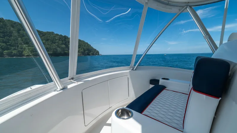 Slide: The Image of Enclosed Flybridge Seating Area This inviting enclosed flybridge on the 2020 Viking 46 BF offers panoramic views of the surrounding seascape. The comfortable seating features plush cushioning with stylish contrast piping, perfect for relaxation while cruising. The expansive windows ensu - 7854771