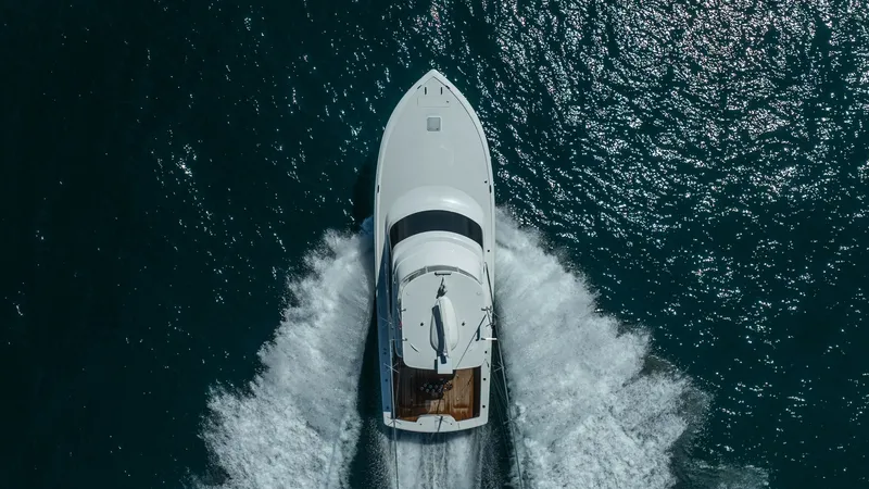 Slide: The Image of Aerial View of Viking 46 BF Bow This striking aerial shot captures the sleek bow of the Viking 46 BF as it cuts through the water with precision. The vessel's streamlined design and spacious deck are evident, showcasing its exceptional craftsmanship and performance. The wake trailing be - 7854786
